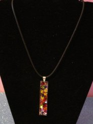 Silver rectangle pendant filled with metallic coloured stars 